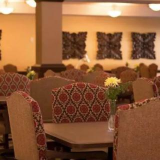 Cozy restaurant dining area with decorative chairs and tables.
