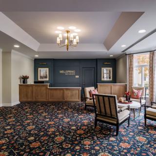 A stylish hotel lobby with a reception desk and a comfortable seating area.