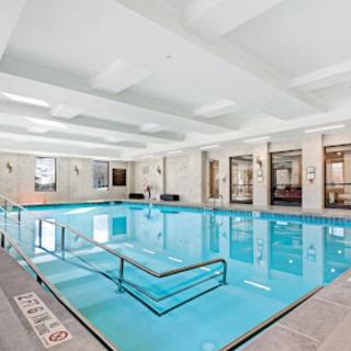 A luxurious indoor swimming pool with elegant surroundings.