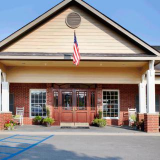 A building with a brick facade and an American flag above the entrance.