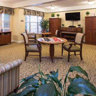 A cozy living area with comfortable seating, a central table, and a television.