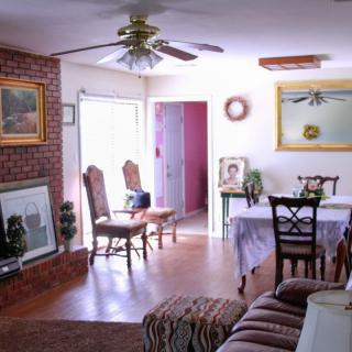 A cozy living and dining area with elegant furnishings and abundant natural light.