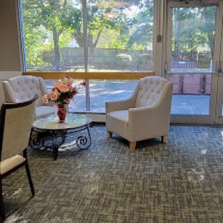 A cozy lounge area with comfortable seating and a view of the outdoors.