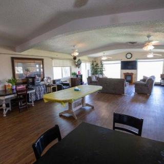 A spacious open-plan living and dining area with comfortable seating and ample natural light.