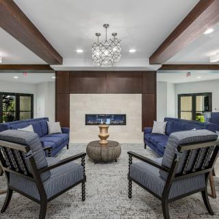 A modern living room with a central fireplace and elegant furnishings.