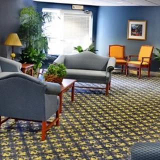 A cozy lobby with comfortable seating and indoor plants.