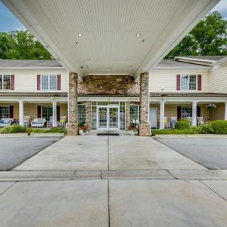 Front entrance of a residential building with a covered driveway.