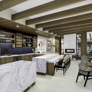 A modern kitchen and dining area with marble countertops and wood beam ceilings.