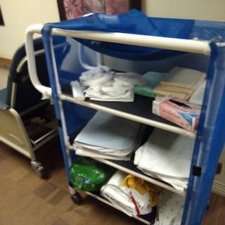 A hospital supply cart filled with various items, including linens and other essentials.