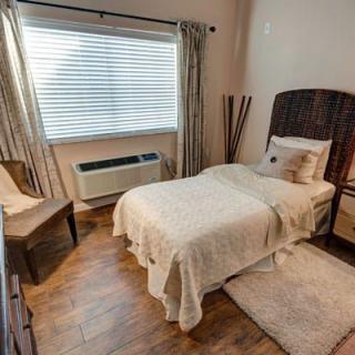 A cozy bedroom with a single bed and warm decor.