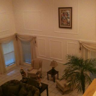 A spacious living room with elegant furniture and decor.