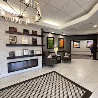 A modern lobby featuring elegant furniture, decorative artwork, and stylish lighting.