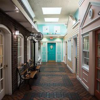 A vintage-themed indoor hallway with decorative elements and colorful doors.