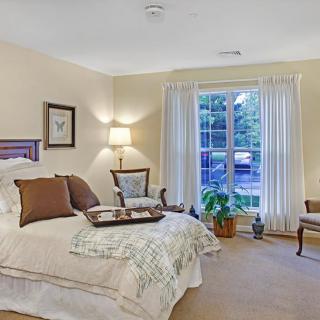 A cozy bedroom with elegant decor and natural lighting.