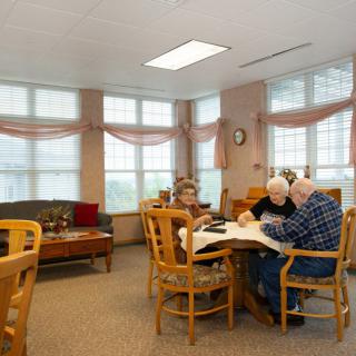Seniors engaged in a group activity at a retirement home.