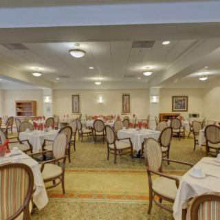 An elegant dining room with neatly arranged tables and chairs.