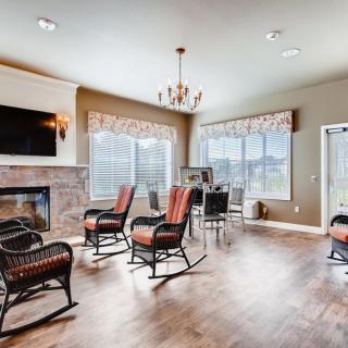 A modern living room with a fireplace, hardwood flooring, and comfortable seating.