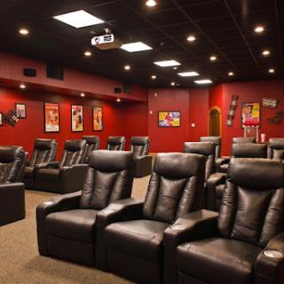 A luxurious home theater with recliner seating and cinematic decor.