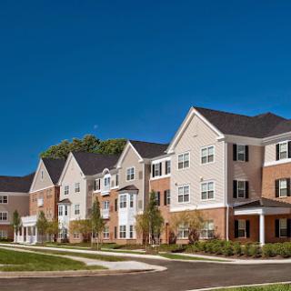 A row of modern apartment buildings under a clear blue sky.