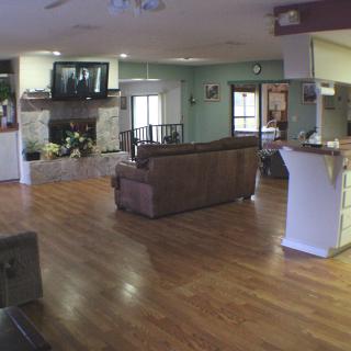 Spacious living room with hardwood flooring and a cozy seating area.