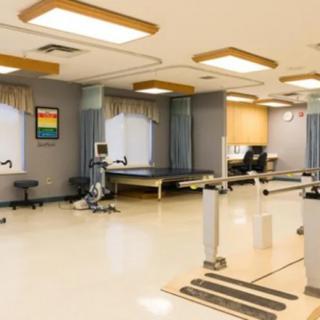 A well-equipped physical therapy clinic with various rehabilitation equipment.
