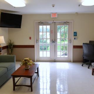A welcoming lobby area with a sofa, coffee table, and access to the outdoors.