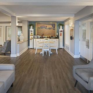 A modern living room with elegant furniture and wood flooring.