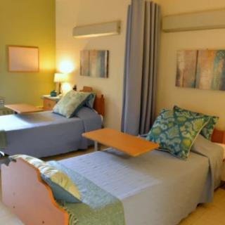 A well-decorated bedroom featuring twin beds with modern and comfortable furnishings.