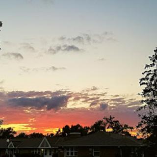 A beautiful sunset paints the sky in vibrant hues, casting a warm glow over the horizon.