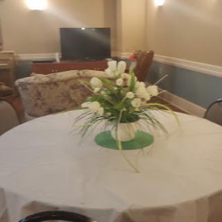 A beautifully arranged floral centerpiece on a dining table in a cozy living area.