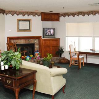 A cozy living room with a fireplace, television, and seating area.
