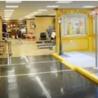An accessible entrance leading into a brightly lit public space with seating areas.