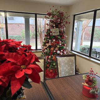 A beautifully decorated Christmas corner with a tree and vibrant poinsettias.