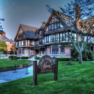 A beautifully preserved historic mansion set in a lush landscape.