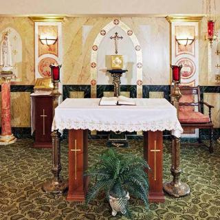 A beautifully decorated church altar with candles and a cross.