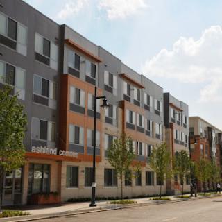 A modern apartment building showcasing contemporary architectural design in an urban setting.