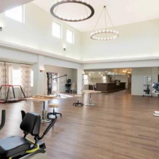 A spacious gym with various exercise equipment.