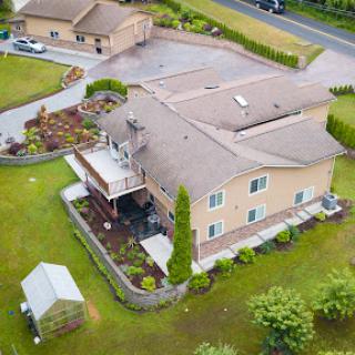 Aerial view of a spacious residential property featuring well-maintained landscaping and outdoor space.