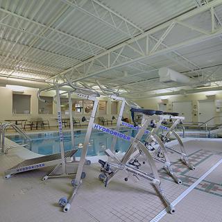 Indoor therapy pool with rehabilitation equipment.