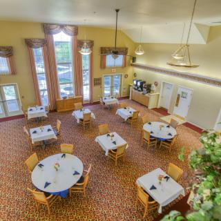 A spacious and elegantly decorated dining area with neatly arranged tables and chairs.