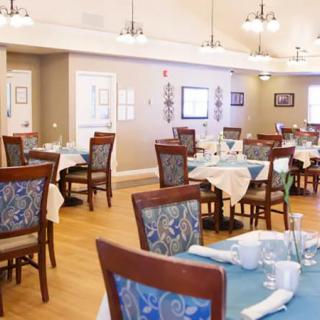 A spacious and elegantly decorated dining room with neatly set tables and chairs.