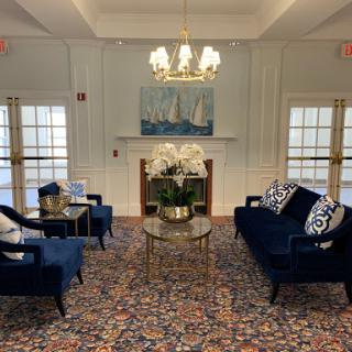 A cozy and stylish living room featuring blue sofas, elegant decor, and a warm atmosphere.