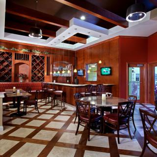 Cozy restaurant interior with elegant table settings and warm decor.