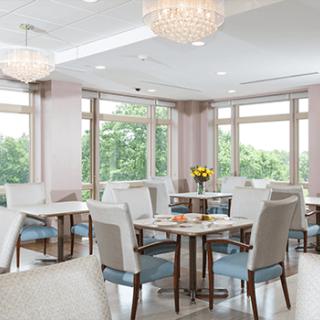 A modern dining area with elegant chandeliers and natural lighting.