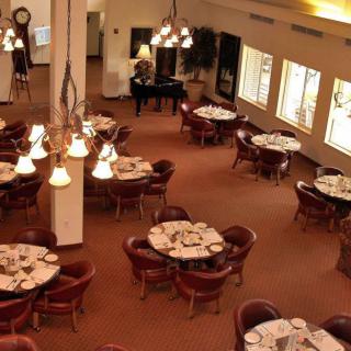 An elegant restaurant dining area with neatly arranged tables and soft lighting.