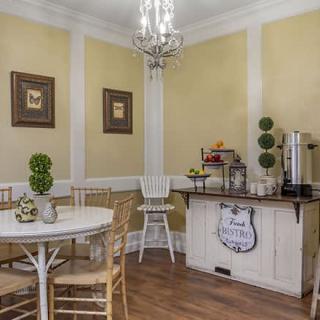 A cozy dining area with a coffee station and elegant decor.