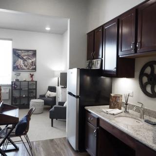 A modern apartment featuring a compact kitchen and cozy living area.