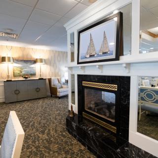 A cozy living room with a fireplace, artwork, and elegant decor.