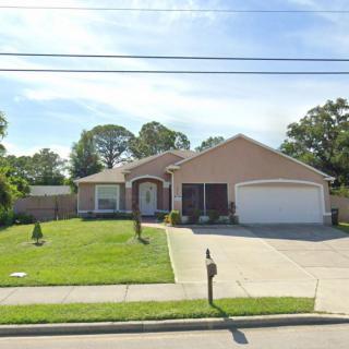 A suburban house with a well-maintained lawn and a two-car garage.