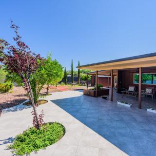 A modern patio with a landscaped garden on a sunny day.